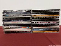Front view of stacked CD spines showing artists and album names.