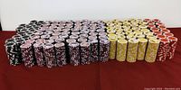 Photo showing rows of sealed poker chip packs in black, purple, yellow, and red.
