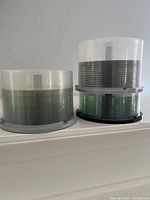 Photo showing two spindle cases of blank discs placed next to each other. Each spindle contains many discs.