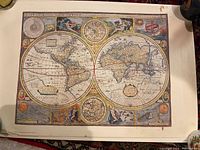 World map reproduction with ornate decorative borders and mythological figures