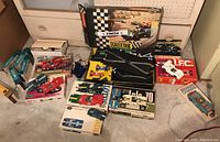 Overview of all lot contents: boxed cars, controllers, track sections, supports and finish line banner