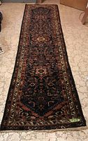 Full view of the wool runner rug showing the full length and all colors and patterns.