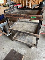 Full view of the rolling cart showing three wooden shelves with metal frame and caster wheels.