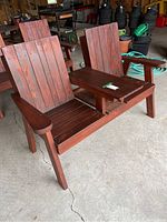 Front-right perspective view of cedar two-seat bench showing slatted seats, backrests, center shelf and armrests
