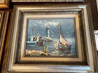 Full view of framed painting showing entire harbour scene and frame