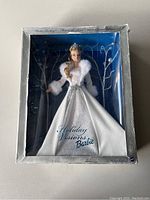 Front view of Holiday Visions Barbie doll in original box showing doll with white dress and tiara, box worn.
