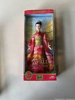 Front view of boxed Dolls of the World Princess of Japan Barbie doll with traditional pink kimono, gold obi, and Japanese temple backdrop inside box. Box has visible wear.