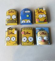 Six collector's box DVDs of The Simpsons seasons 6 through 11, each with unique character face designs on the cases.