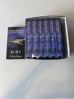 Photo of set of 7 VHS tapes featuring World War 2 warbirds: P-51 Mustang, P-38 Lightning, B-29 Superfortress, B-17 Flying Fortress, P-47 Thunderbolt, P-40 Warhawk and B-24 Liberator.