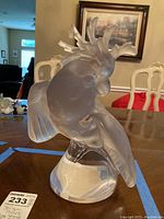 Front angle view of frosted glass crystal cockatoo perched on circular base