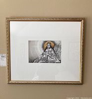 Full photo showing the ornate gold frame and centered sketch of indigenous woman seated with gold halo.