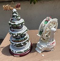 Thomas Kinkade Wonderland Express Christmas Tree detail with train and Santa's sleigh, multi-tiered with snow and holiday scenes