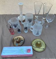 Overview of all glassware items including mugs, shot glasses, tall glasses, wine glass, metal hats and the boxed rose