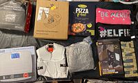Full overview of all miscellaneous household items in lot including foot spa massager, clothing, digital scale, kitchen accessories.
