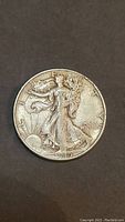 Obverse of the 1945 Liberty Half Dollar showing Lady Liberty walking with rays of sun behind her and the date 1945.
