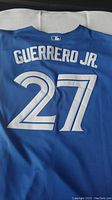 Back of blue baseball jersey with 'GUERRERO JR.' name and number 27 in white stitching.