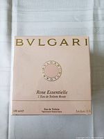Front of Bvlgari Rose Essentielle box showing branding, fragrance name, volume (100ml/3.4 fl oz), and type (Eau de Toilette).