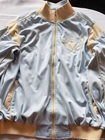Front view of the light blue jacket with beige accents and Blue Jays logo on left chest.