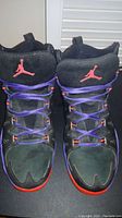 Top-down front view of both shoes showing toe box, lacing, Jumpman logos on tongue