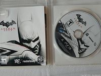 Photo of open game case showing disc and inside artwork.