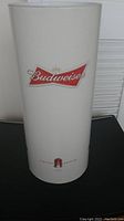 White cylindrical cardboard container with Budweiser logos