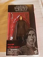 Two photos of Kylo Ren Black Series action figures in their original packaging showing figure and accessories.