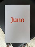 Front cover of a white notebook with the word 'Juno' in orange lettering.