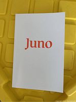 Front cover of Juno notebook with orange logo on white background.
