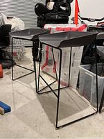 Two stools in garage with surrounding storage items, angled front view