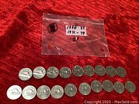 Two rows of Canadian nickels from 1971-79 and 1980-89 shown on a red cloth, with a plastic bag labeled with these date ranges.