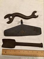 Full view of the 8-inch iron wrench, 9-inch hoe head, and 9-inch wedge with ruler showing size