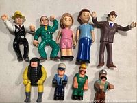 Overview of all plastic figurines from vintage toy collection including characters resembling Little Tikes, Dick Tracy, Roger Rabbit, FisherPrice, and Ghost Busters