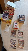 Open box with multiple stacks of 1990 NFL Pro Set football cards, various players visible including first round draft picks.