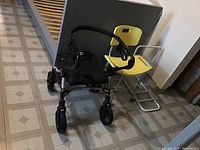 Front view of Evolution walker and yellow shower chair on tiled floor