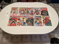 Ten Marvel comic books laid out in two rows on white table