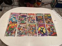 Overview of all ten comics arranged on table