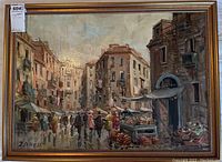 Oil painting of a busy street market scene with people and buildings, signed Zanelli in lower left corner.