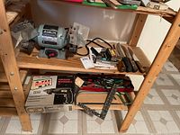 Overview photo showing the Delta bench grinder on the shelf beside the boxed Craftsman reversible drill along with chisels and other hand tools