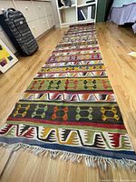 Full-length view of runner laid on hardwood floor showing overall pattern and length.