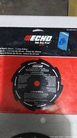 Photo of an Echo branded saw blade, black with 8 teeth, mounted on red packaging with Echo branding and product details.