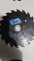 Top view of a black 7 1/4 inch circular saw blade with 24 teeth, showing etched text and a blue label sticker.