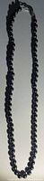 Full length view of the black pearl necklace showing overall strand and clasp.