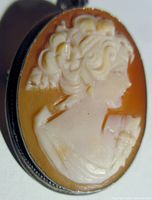 Close-up of the hand carved cameo profile in vintage sterling bezel, showing detailed carving and bezel edge.