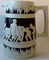 Side view of antique football-themed pitcher highlighting detailed embossed cameo football player scenes in ivory over dark brown.
