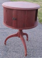 Photo of the closed drum style wooden table with two doors and curved legs.