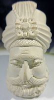 Close-up of the hand carved meerschaum pipe bowl showing detailed bearded man wearing a turban with hat badge.