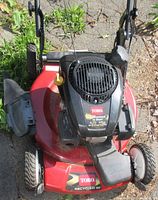 Top view showing red metal deck, black Toro engine cover, and yellow oil cap.