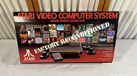 Front of original Atari 2600 box showing ‘Factory Reconditioned’ branding and product images