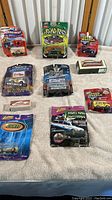 Full collection of various diecast cars in blister packaging, impacted by water damage and wear, showing total lot contents.