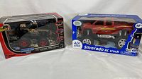Two boxed RC trucks: New Bright Monster truck and Just Kidz Silverado truck.